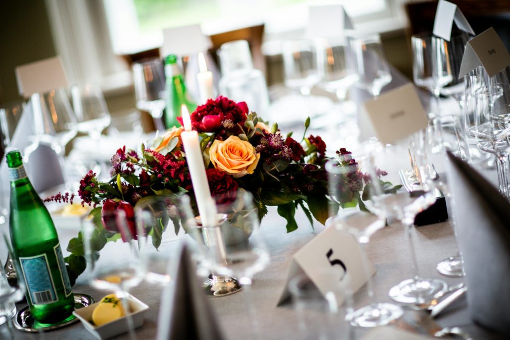 Elegant dining setup with floral centerpiece and decorated tables ready for an event.
